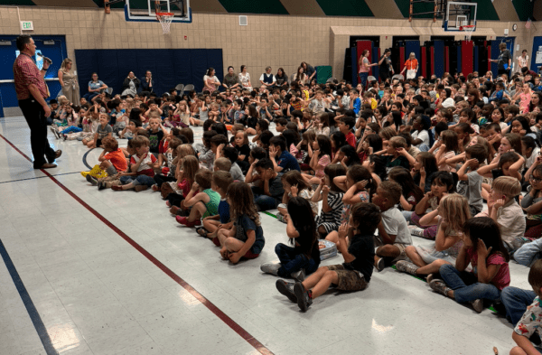 students listening to Mr. Burge introduce the Utah Opera